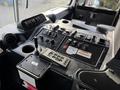 The interior control panel of a 2010 Autocar Xpeditor featuring various switches buttons and a gear shift lever