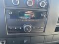 A close-up of the dashboard area of a 2013 Chevrolet Express featuring the radio display and control buttons