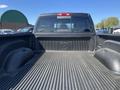 A 2011 RAM 1500 truck bed showing the textured lining with a logo in the center and wheel wells on either side