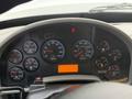 Dashboard of a 2016 International 7400 featuring various gauges for RPM speed fuel and temperature with an illuminated warning light