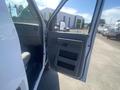 A 2009 Ford Econoline van with the front door open showing the interior and driver's seat