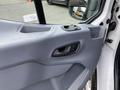 Interior view of a 2017 Ford Transit door panel featuring a handle and window control buttons
