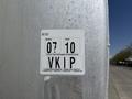 Close-up of a vehicle inspection sticker showing the month 07 and year 10 along with the letters VKIP indicating type of test performed