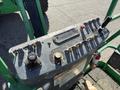 Control panel of a 2015 JLG 450AJ with various levers buttons and gauges for operation