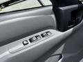 Close-up of the interior door panel of a 2018 Hino 195 featuring power window controls and a door handle