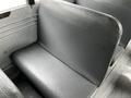 Interior view of a 2015 Spartan school bus showing a single black vinyl seat with a textured surface and metal framing