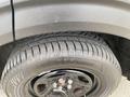 Close-up of a black tire on a 2021 Ford Explorer with the tread pattern visible and the rim design highlighted