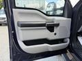 A 2017 Ford F-550 door panel featuring a gray and black design with a door handle and a storage compartment