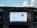Interior dashboard display of a 2023 Ford F-550 showing radio station information and options for audio and phone connectivity