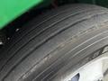 Close-up of the tire of a 2015 Freightliner M2 106 showing tread patterns and sidewall markings