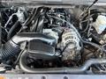 A 2011 Chevrolet Avalanche engine with various components including the alternator air intake and belts prominently displayed