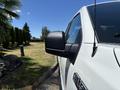 A white 2016 Ford F-150 with a side view mirror is prominently displayed in the foreground