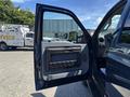 A 2014 Ford F-250 SD with an open driver's side door showcasing the interior door panel and controls