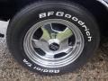 Close-up of a tire and wheel from a 1974 Dodge Challenger featuring a polished chrome rim and white lettering on the tire sidewall