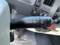 Close-up of the control stalk in a 2015 Isuzu NPR featuring icons for turn signals wipers and headlights