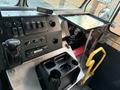 Interior view of a 2017 Freightliner M Line cabin featuring a dashboard with switches a control handle and a cup holder unit