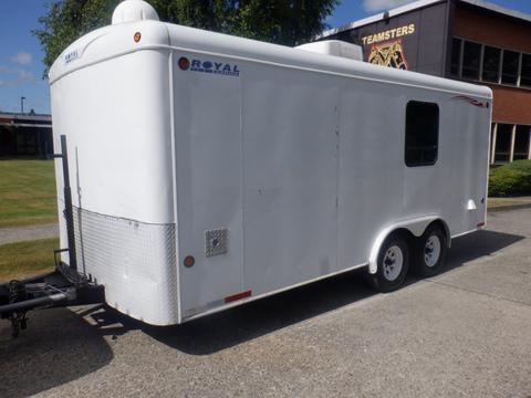 A 2004 Royal 18 Foot Office Trailer with a white exterior and dual axles featuring a rear door and windows on one side
