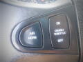 Close-up of control panel buttons in a vehicle with labels for air horn and cruise/throttle settings