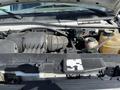 Engine compartment of a 2008 Ford Econoline showing various components including the air intake and coolant reservoir