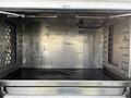 A 2018 Ford F-550 with a modified cargo area featuring metal walls and a flat, clean floor with some water residue