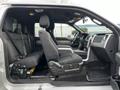 A 2014 Ford F-150 with a spacious interior features front bucket seats and a rear bench seat with black fabric upholstery and a central console