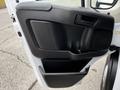 The interior door panel of a 2021 RAM Promaster featuring a black plastic design with a handle and speaker grille