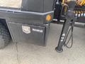 Close-up of a 2017 Ford F-550's tool storage compartment labeled Buyers with a hydraulic lift component beside it