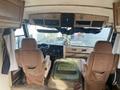 Interior of a 1987 Chevrolet Fleetwood Pace Arrow featuring two upholstered front seats and a dashboard with various controls and a steering wheel