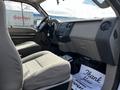 Interior view of a 2008 Ford F-550 with gray cloth seats and a simple dashboard featuring controls and a gear shift