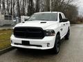 A 2022 RAM 1500 Classic in white with a black grille and accents parked on a roadway