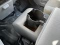 A 2011 Ford F-450 SD center console with an empty cup holder insert removed from the top