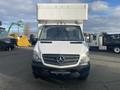 A 2017 Mercedes-Benz Sprinter van with a large white cargo box on the back and distinctive front grille and headlights