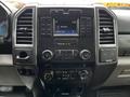 Dashboard of a 2017 Ford F-550 featuring a display screen with radio controls and climate settings