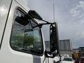 2012 Volvo VNL truck with a prominent side mirror and window visible in the foreground