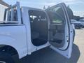A 2017 Ford F-150 with the passenger door open showing the interior seats and trim details