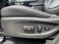 Close-up of the seat adjustment controls on the driver's side of a 2015 Kia Sorento with a black leather seat