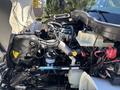 Engine compartment of a 2008 International DuraStar showing various components including pipes hoses and fluid reservoirs