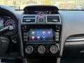 Dashboard of a 2021 Subaru WRX featuring a touchscreen display with various app icons and climate control dials