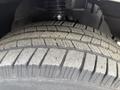 Close-up of a tire from a 2012 Mercedes-Benz Sprinter showing tread patterns and wear on the rubber surface
