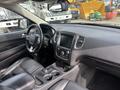 Interior view of a 2015 Dodge Durango showing leather seats a central console and dashboard with a touchscreen display and controls