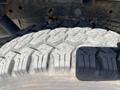 Close-up of a rugged tire tread from a 2012 Ford F-150 showcasing deep grooves and an aggressive design