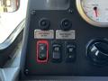Dashboard controls of a 2006 Emergency One Fire Truck showing buttons for left and right mirror adjustments as well as battery ignition stop start and fast idle settings