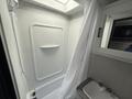 Interior of a 2022 Keystone Hideout RDWE 20RDWE showing a compact shower area with a white curtain and a small sink with two faucet handles