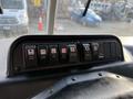The dashboard of a 2010 Autocar Xpeditor featuring various control buttons for cruise control headlights and other functions