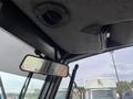 Interior view of a 2012 Toro Groundsmaster 5910 showing the dashboard and rearview mirror with controls and a black ceiling
