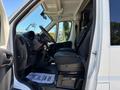 Interior view of a 2016 RAM Promaster with black upholstery and a driver seat positioned in the foreground