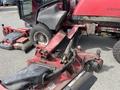 A red 2012 Toro Groundsmaster 5910 with visible cutting decks attached and large rear wheels designed for landscaping and turf maintenance