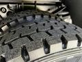 Close-up of a rugged tire from a 2009 Ford F-550 showing detailed tread patterns and robust rubber construction