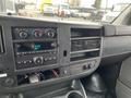 Dashboard of a 2012 Chevrolet Express showing the radio climate controls and air vents with exposed wiring and no visible screen