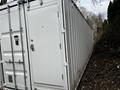 A 40 foot custom climate controlled storage container with a white exterior and a side door featuring a keypad lock